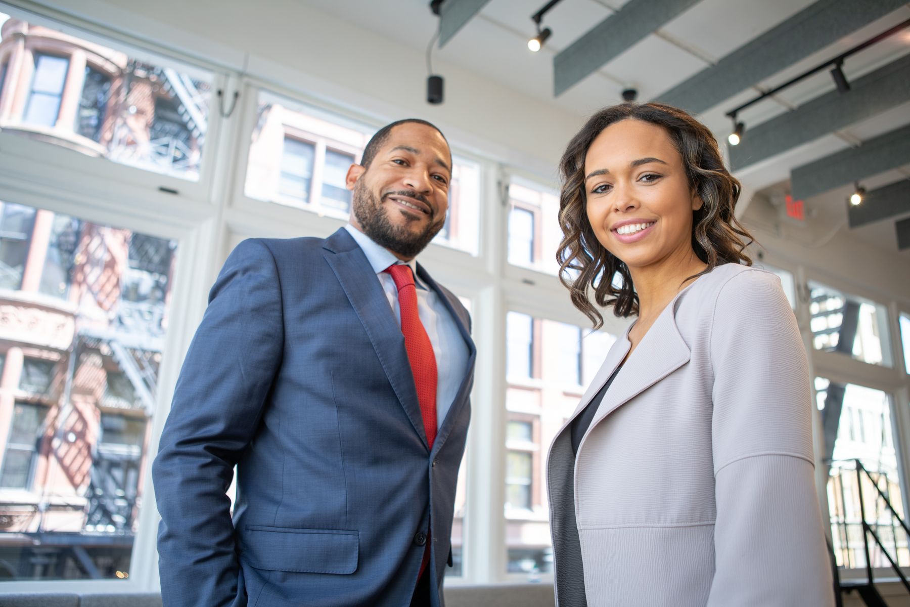 Two Black business professionals in a bright modern office