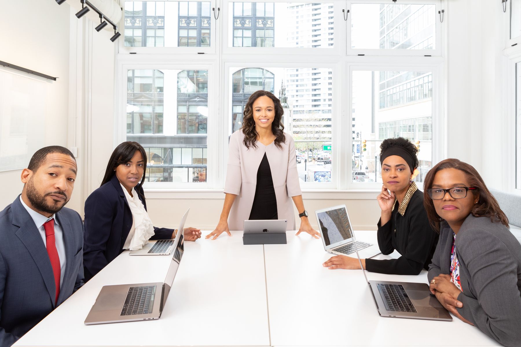 Black business professionals collaborating around an office meeting table